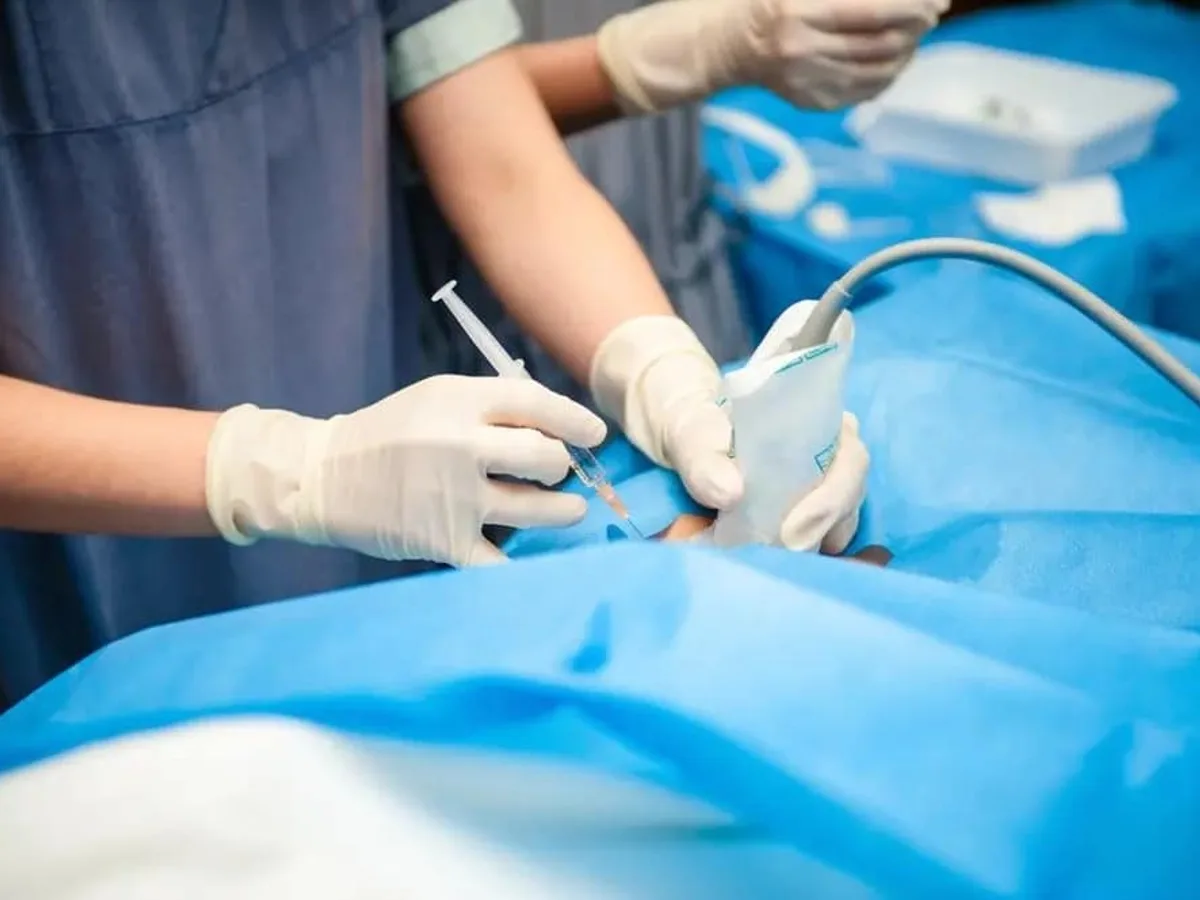 Doctor performing an ultrasound-guided injection procedure